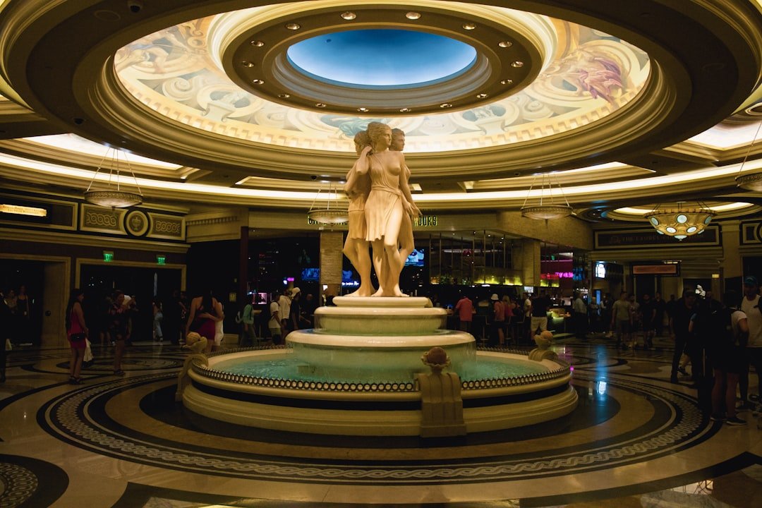 Hotel in Caesars Atlantic City - a statue in a large room with people and a large ceiling