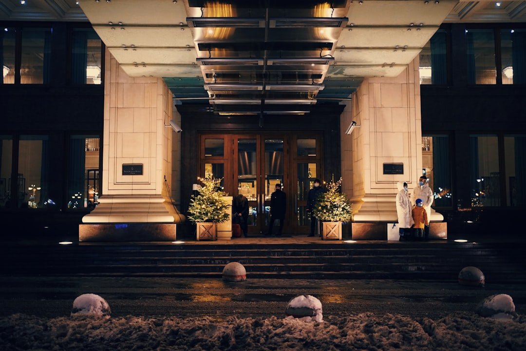 a hotel entrance at night with people entering