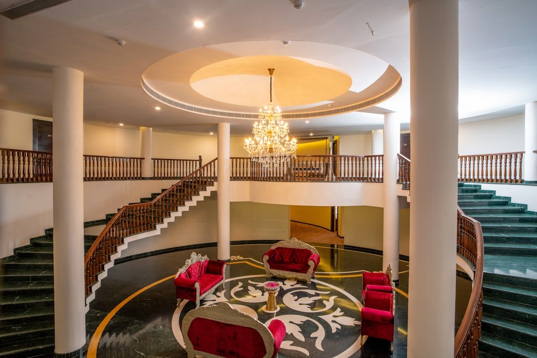 Luxurious hotel lobby features a grand staircase.
