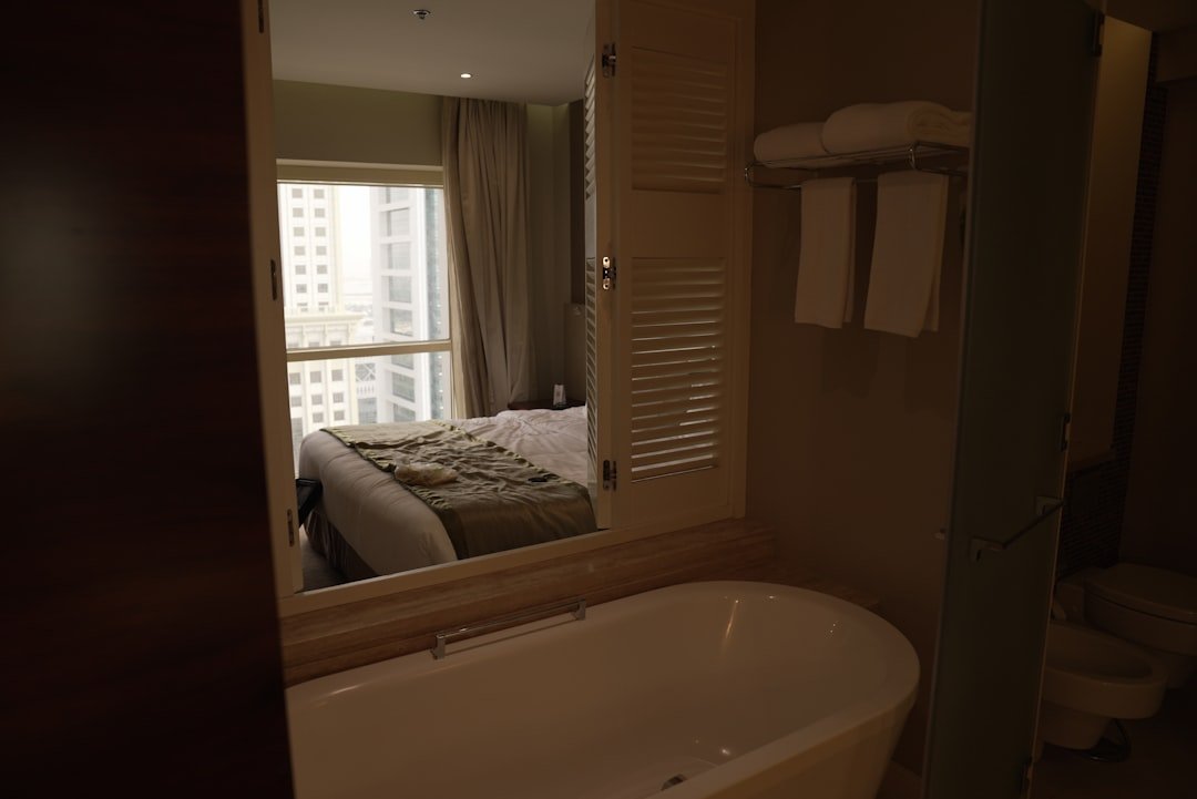 Hotel in Showboat Hotel - a bathroom with a tub and a large mirror